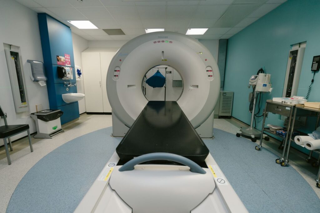 A high-tech MRI machine in a spacious hospital examination room, ready for medical scanning.