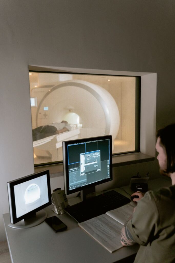 pexels photo 7088538 Health worker examines MRI scan data in a clinical setting.