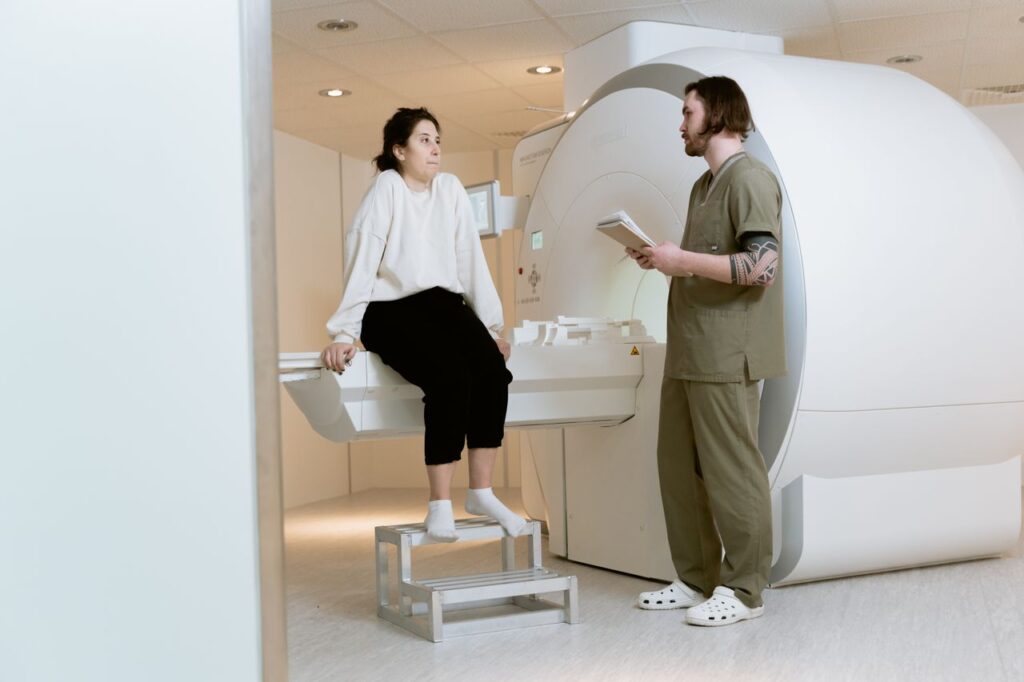 pexels photo 7089395 A patient consults with a technician in a modern MRI room, highlighting advanced healthcare facilities.